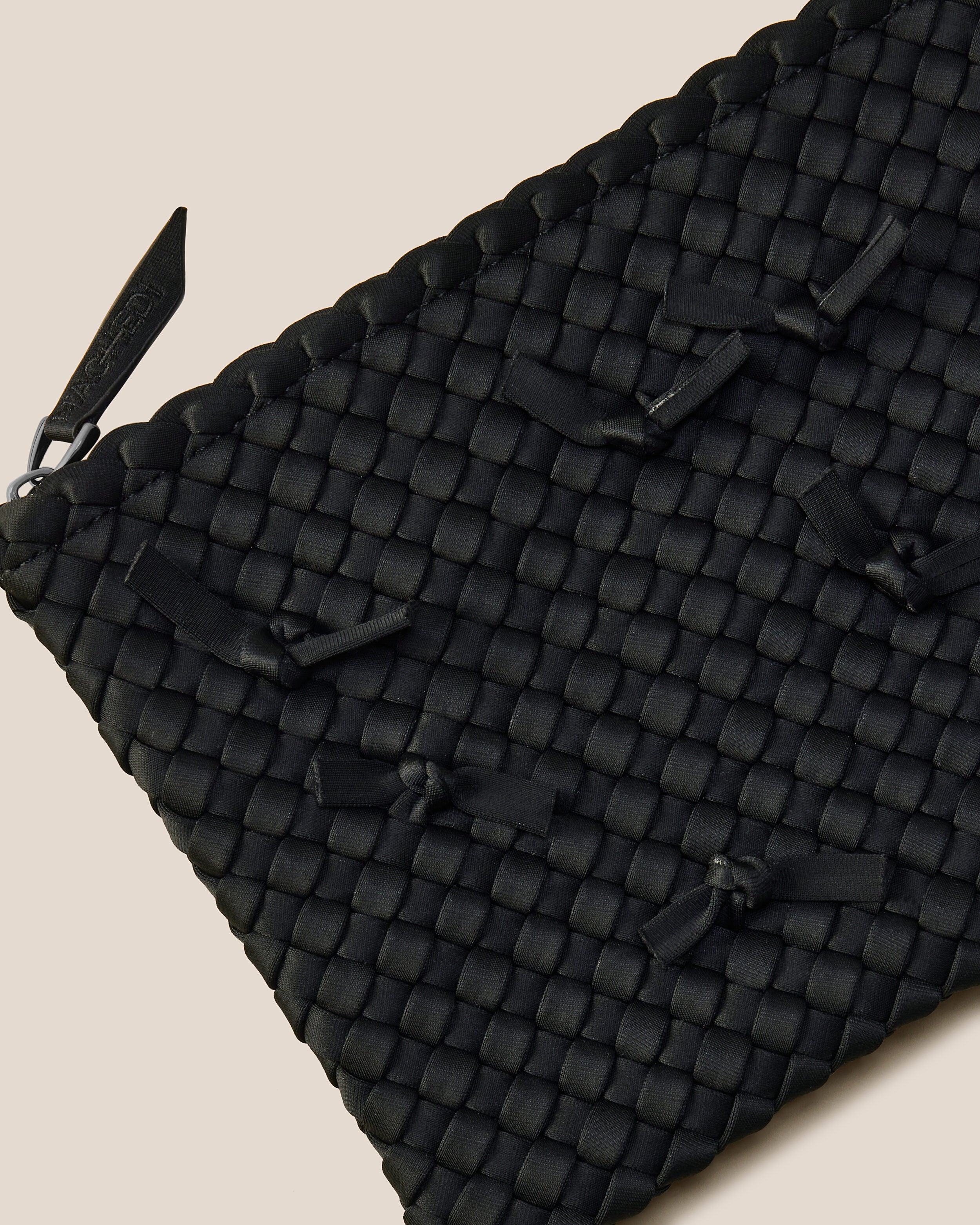 Close-up of included matching woven zippered pouch.