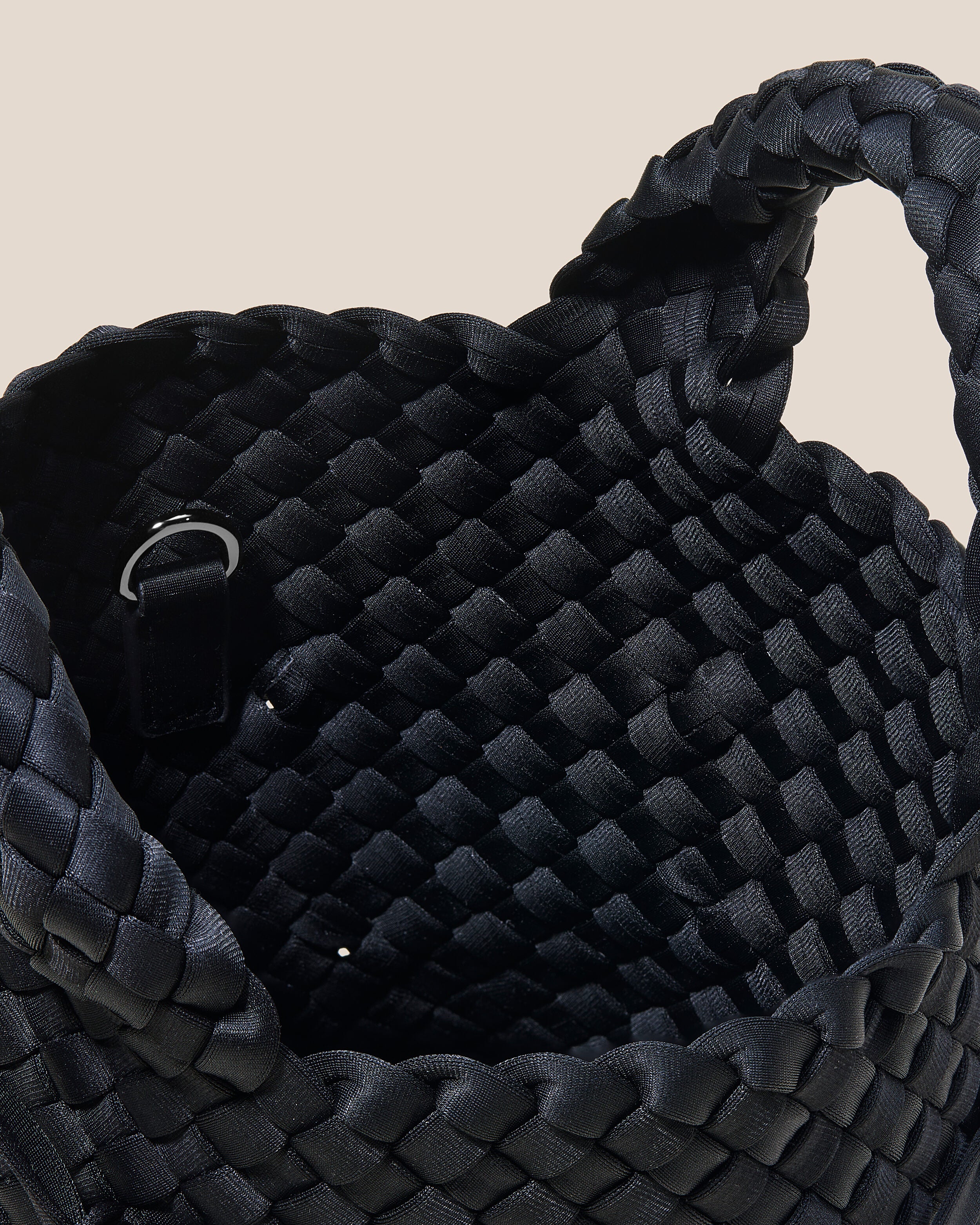 Interior close-up of St. Barths Tote in Onyx showing its open top, and unlined interior.