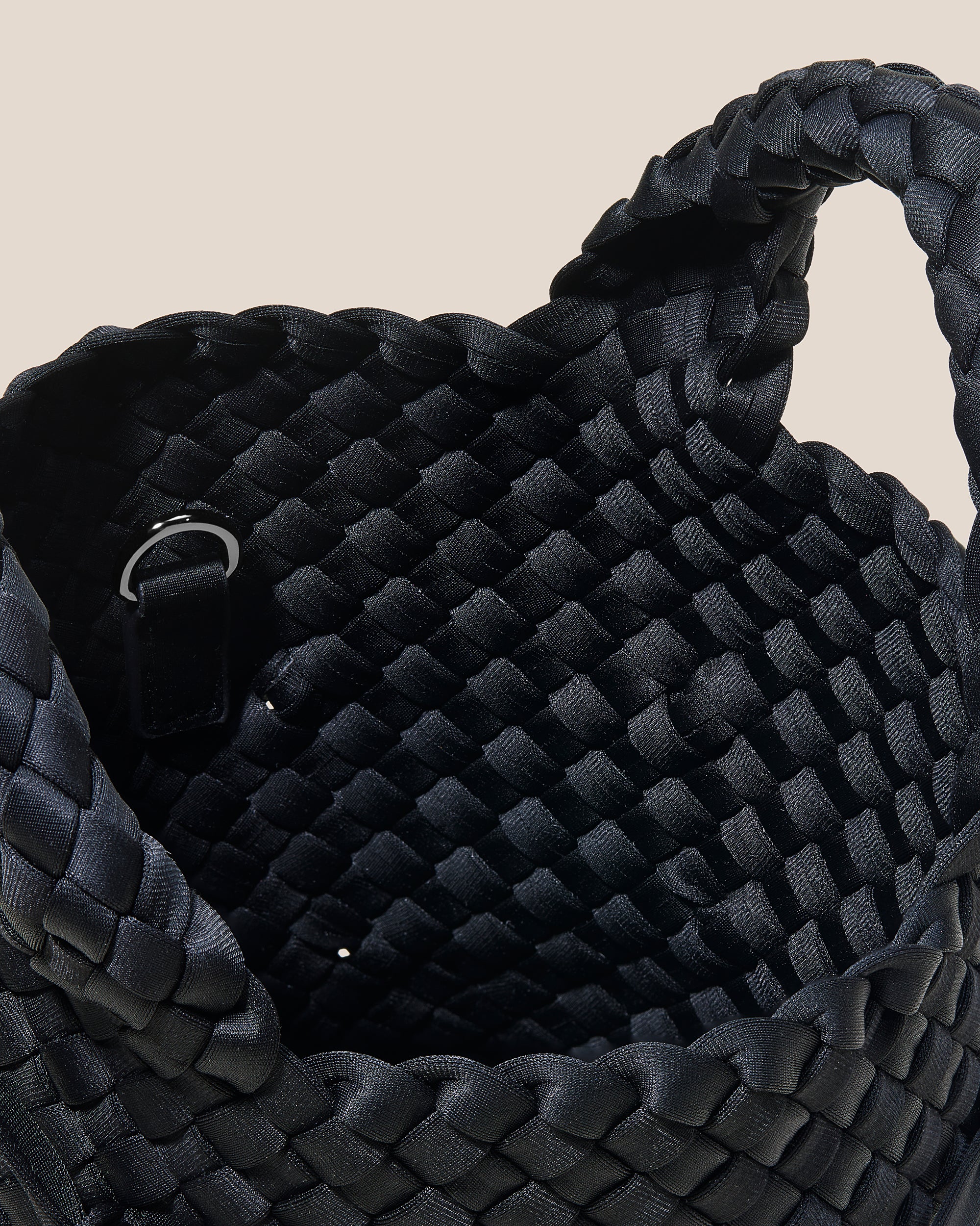 Interior close-up of Waste Not St. Barths Petit Knots Tote Bag in Onyx showing its open top, and unlined interior.