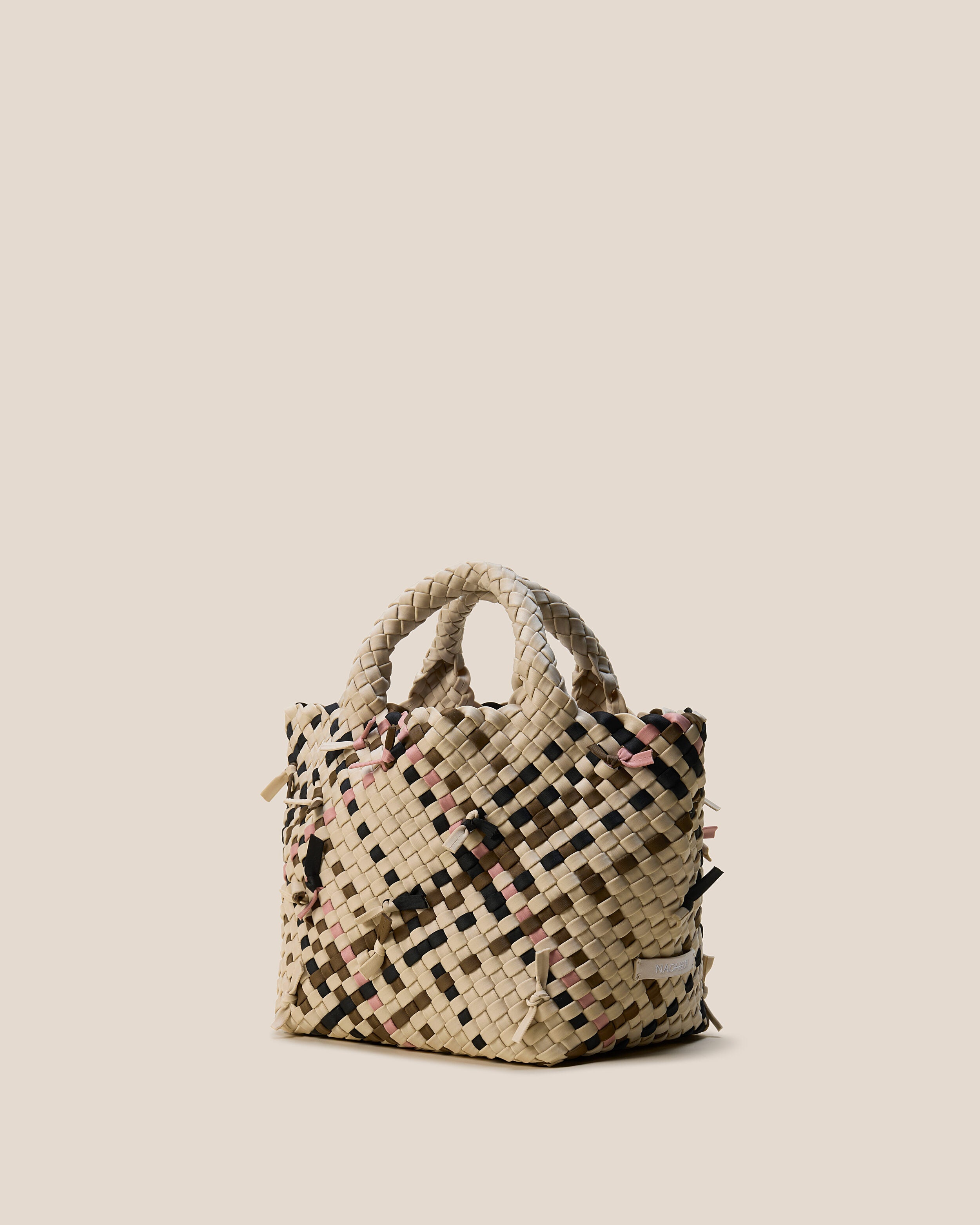 St. Barths Tote in Quartz shown from a side angle, highlighting its handwoven neoprene construction and open top.