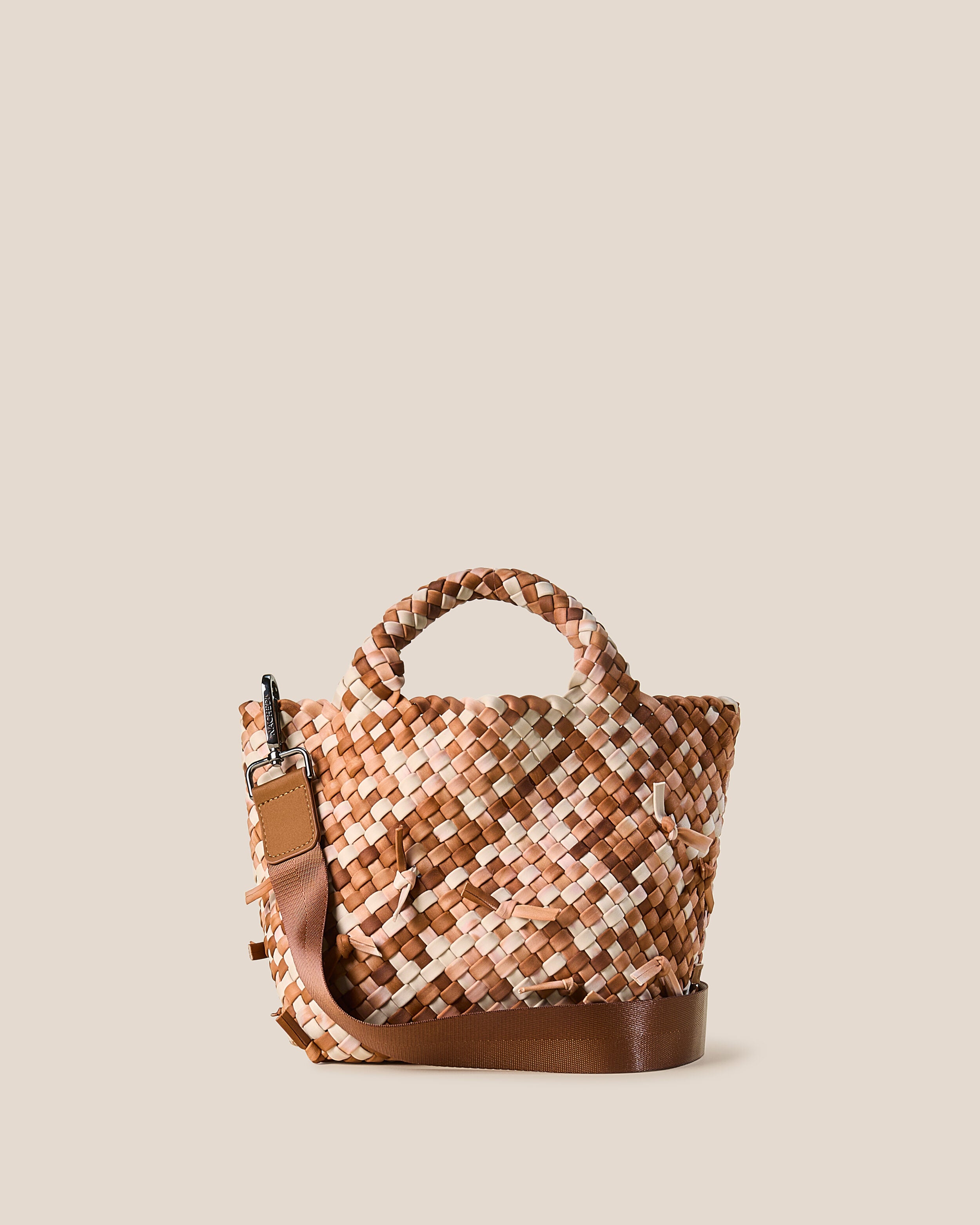 St. Barths Tote in Fawn, a cream and true saddle brown tone, in handwoven neoprene, featuring an open top, woven top handles, and detachable, adjustable nylon crossbody strap.